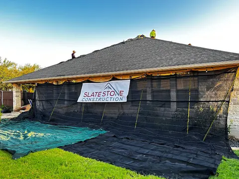 Slate Stone Construction crew installing a new roof on a Texas home